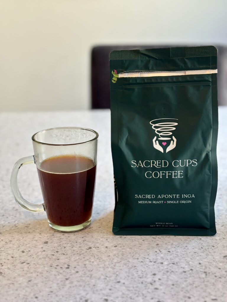 One of the Best Coffees to Try, a cup of Aponte Inga Medium Roast in a clear black mug next to the bag.