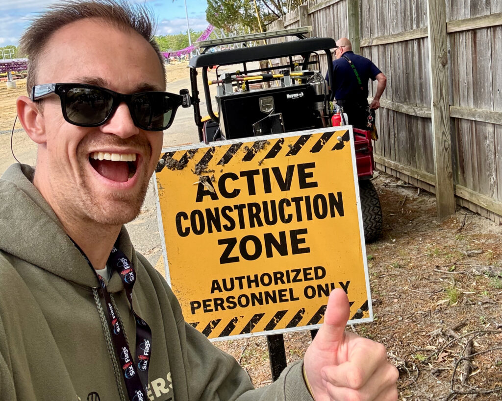 Six Flags Great Adventure review selfie in front of an Active Construction Zone sign during a behind-the-scenes construction tour.