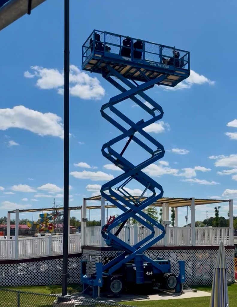 Diggerland USA Review photo showing a blue scissor lift high in the air
