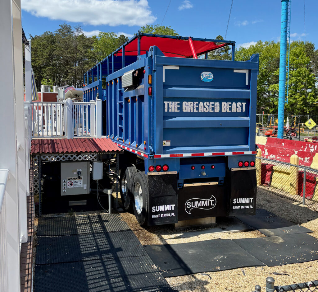 Diggerland USA Review photo showing the outside of a large blue dump truck with "The Greased Beast" written on the back