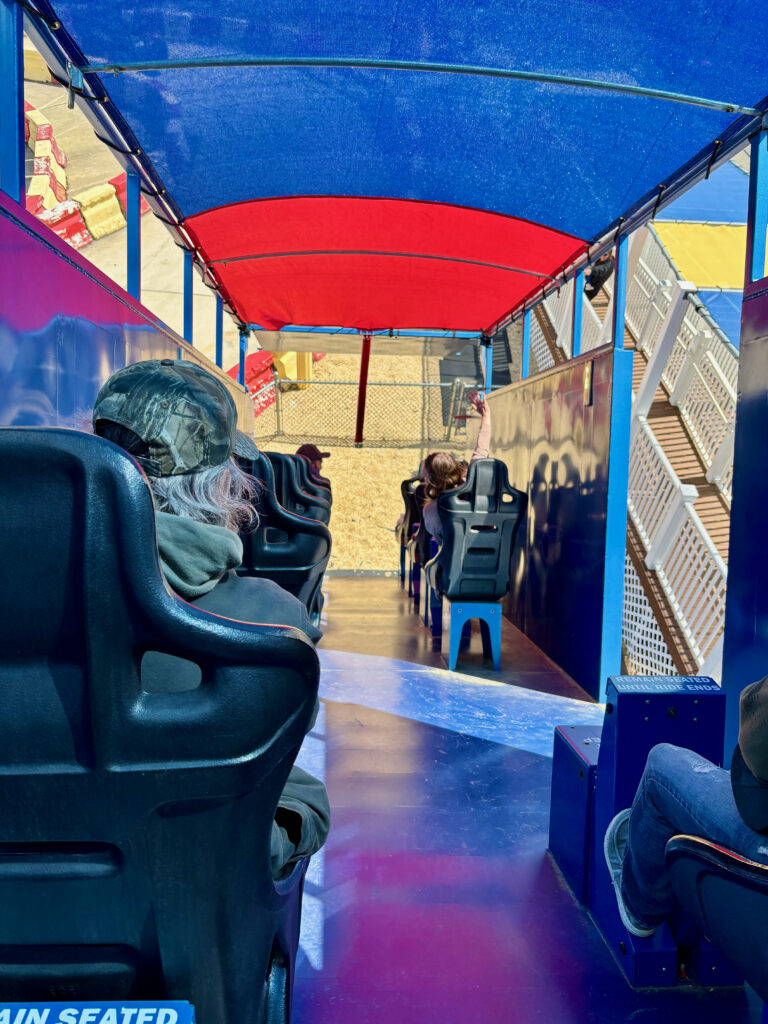 Diggerland USA Review photo showing a row of seats in the back of a dump truck on an include