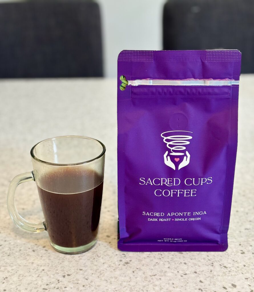 Sacred Cups Aponte Inga Dark Roast coffee bag with French press brew, featuring one of the best dark roast coffees